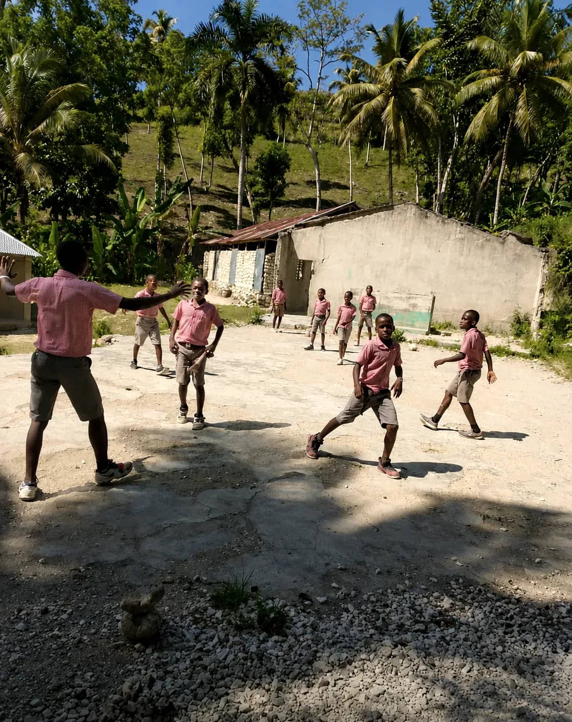 Children play together outdoors in an HEF school courtyard