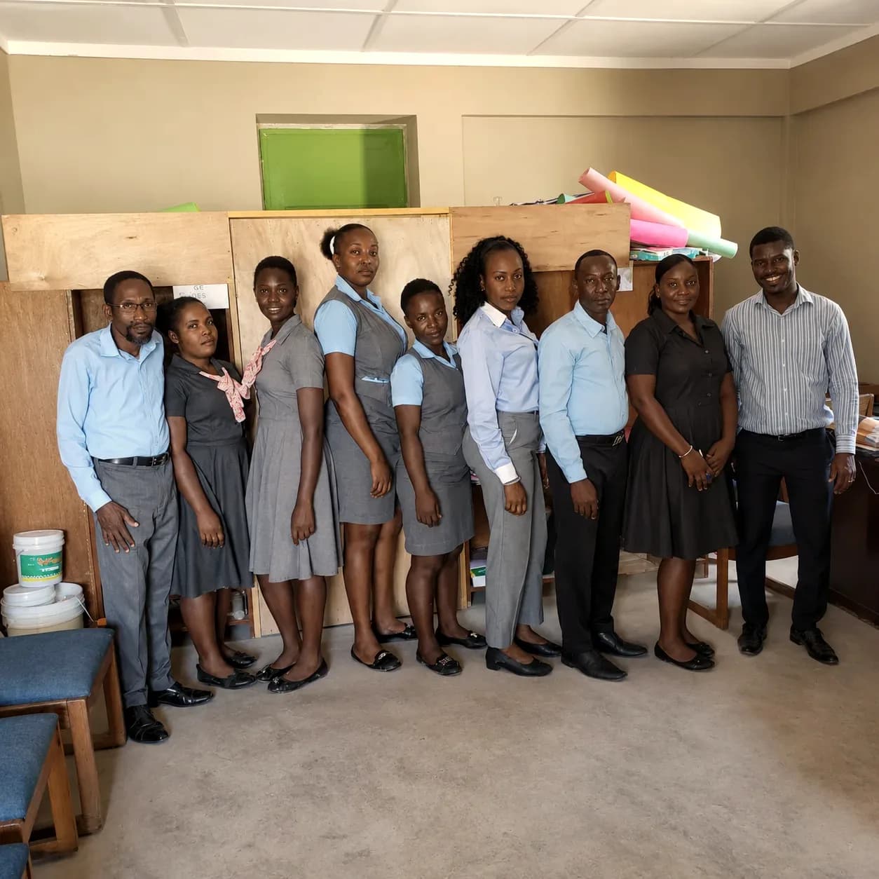 HEF school staff and students standing together indoors